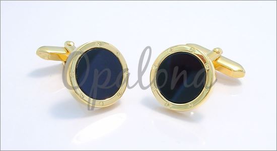 Gilded oval cufflinks with screws and a black core