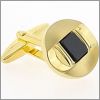 Gilded oval cufflinks with a black core