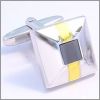 Square cufflinks with a gilded stripes and a grey stone center