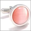 Round cufflinks with a pink cat's eye