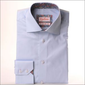 LIght blue shirt with multicolor patterned collar and cuffs