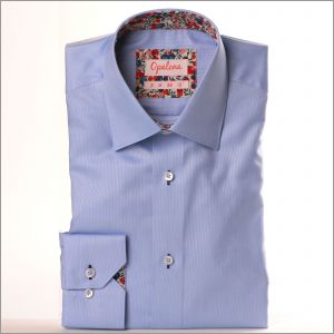 Blue shirt with red, pink and purple floral collar and cuffs