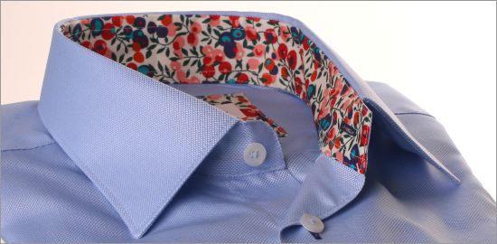 Blue shirt with red, pink and purple floral collar and cuffs